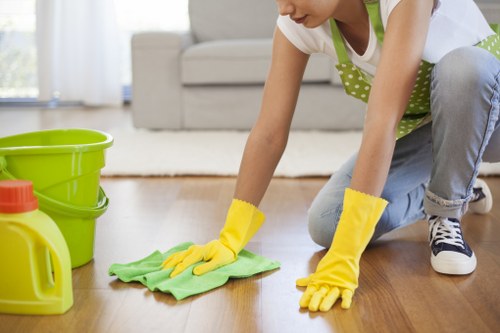 Cleaner using protective equipment while operating carpet cleaning machinery